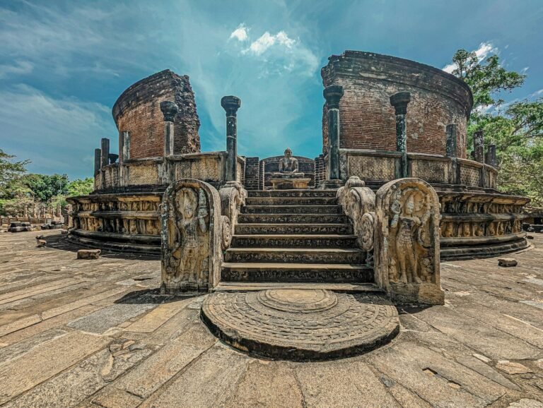 an old building with a bunch of statues around it